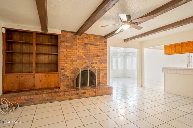 a view of a utility room with closet cabinet and a living room