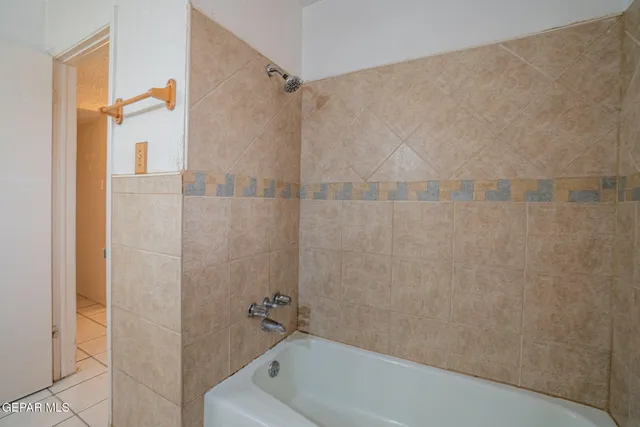 an empty room with a window and wooden floor