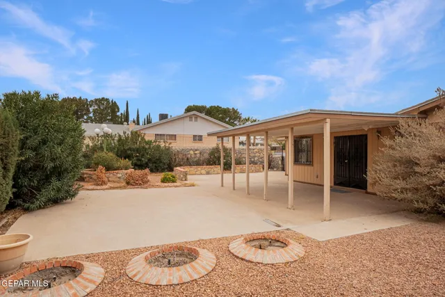 a view of an empty room with wooden floor and windows