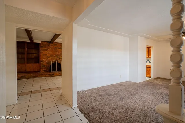 an empty room with a ceiling fan and a window