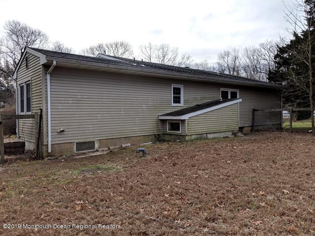 477 Pfister Road Jackson, NJ 08527 - Photo 19 of 21 a backyard of a house with large trees and barbeque oven