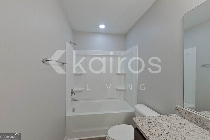 102 Colonial Way Springfield, GA 31329 - Photo 15 of 28 a bathroom with a granite countertop sink toilet and shower