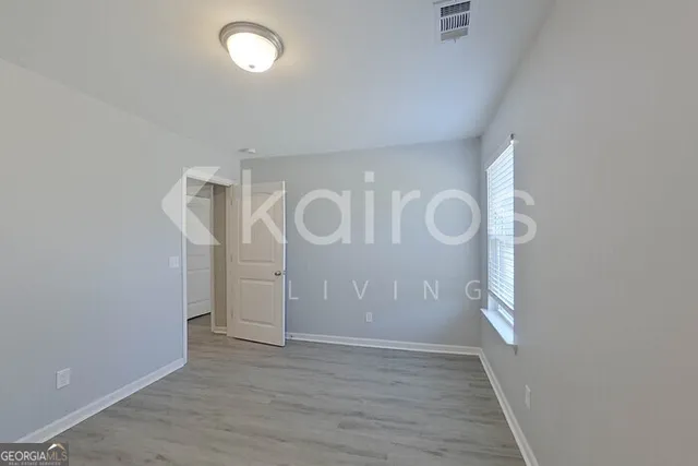 a view of a room with wooden floor