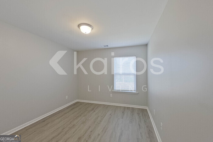 102 Colonial Way Springfield, GA 31329 - Photo 19 of 28 an empty room with wooden floor and windows