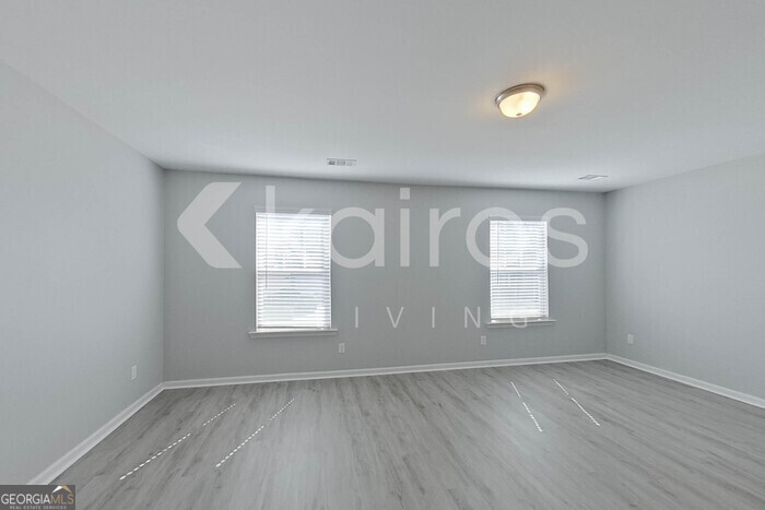 102 Colonial Way Springfield, GA 31329 - Photo 22 of 28 an empty room with wooden floor and windows