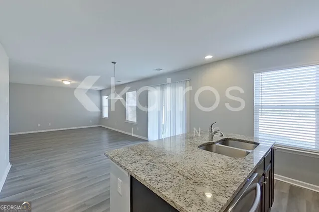 a kitchen with a sink a counter space and a stove