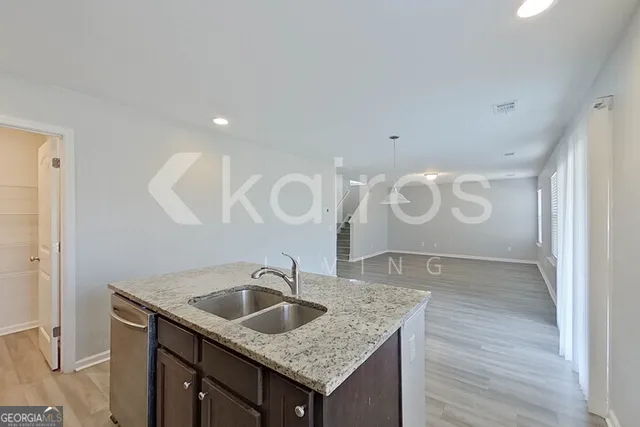 a bathroom with a granite countertop sink a mirror and vanity