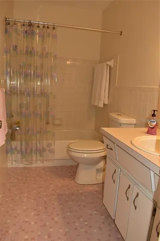 a bathroom with a shower a toilet and a sink