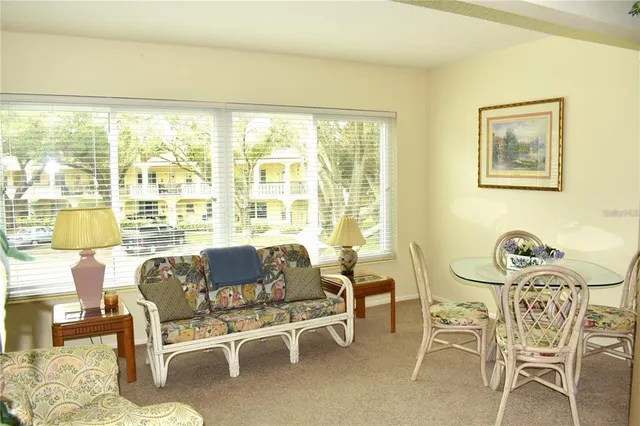 a living room with furniture and a floor to ceiling window
