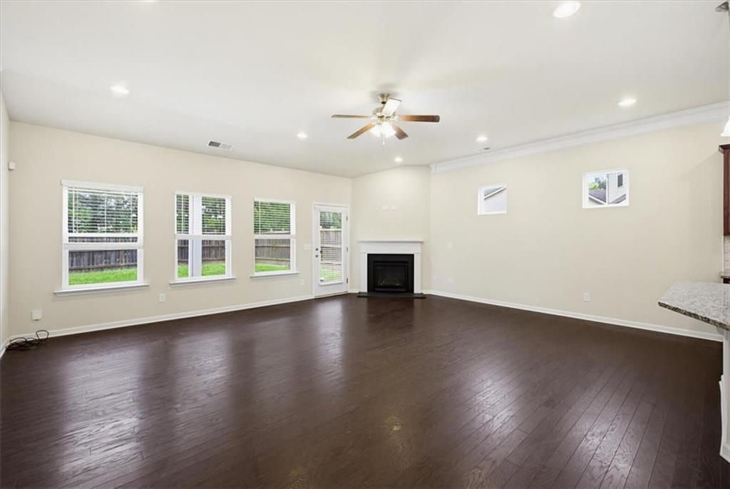 314 Boulder Run Hiram, GA 30141 - Photo 12 of 31 a view of empty room with wooden floor and fan
