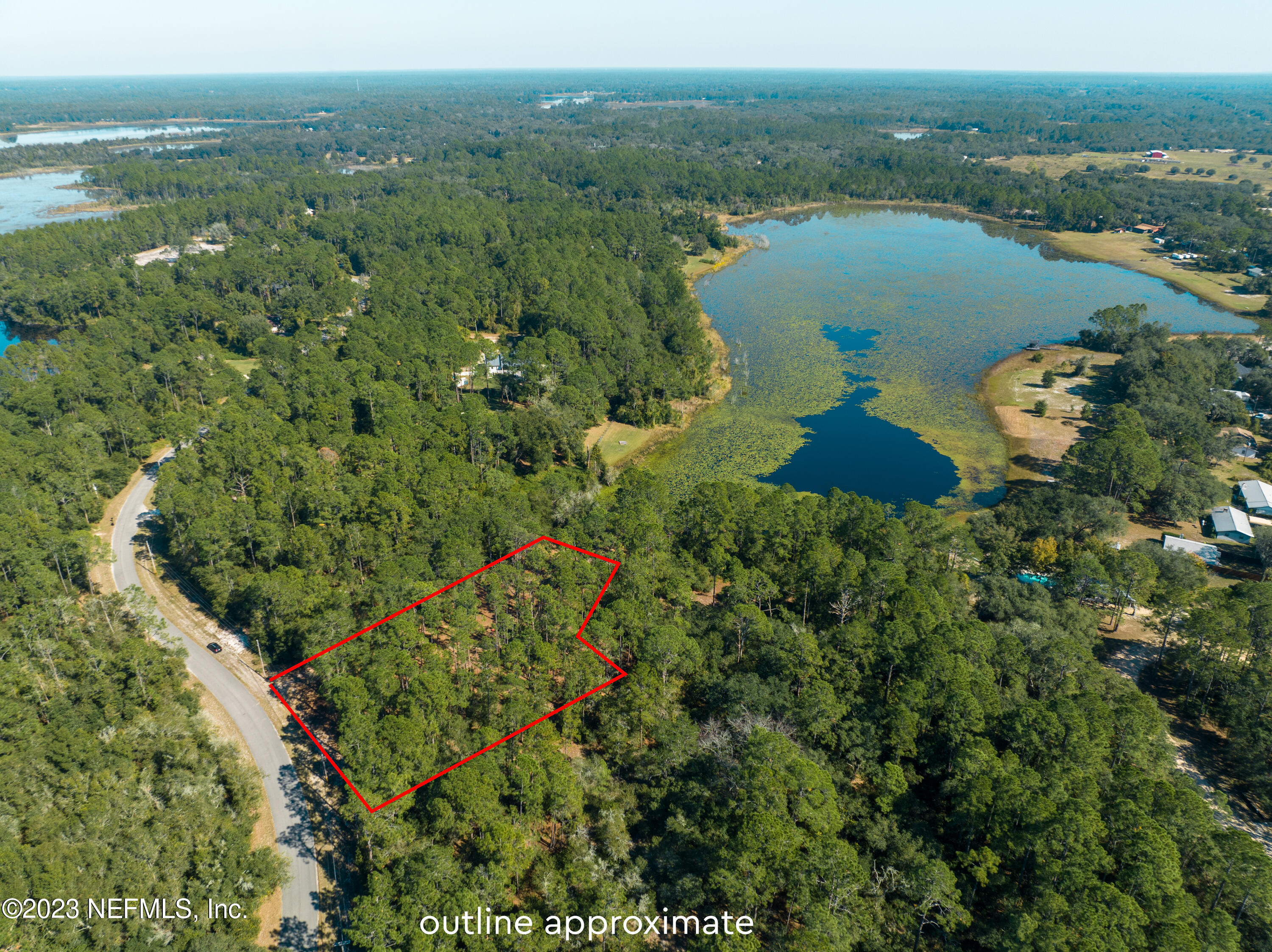 5495 Laredo Street Keystone Heights, FL 32656 - Photo 16 of 22 an aerial view of a house with a lake view