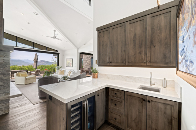 11547 Soaring Hawk Lane Hideout, UT 84036 - Photo 11 of 43 Wet bar featuring wood-finish cabinetry, light-toned countertops, and an integrated sink