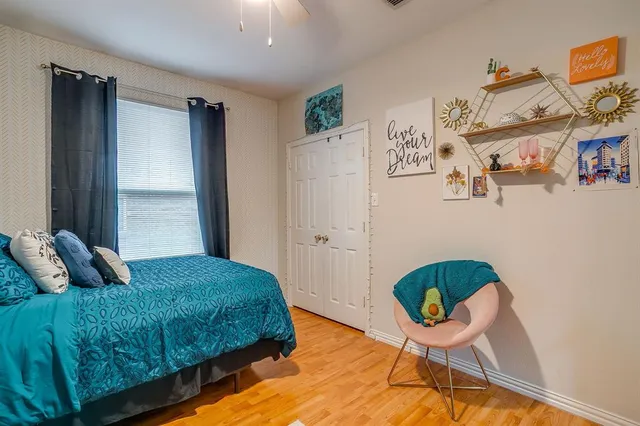 a bedroom with a bed and a window