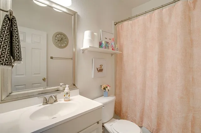 a bathroom with a sink a toilet and a mirror