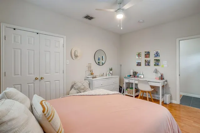 a bedroom with a large bed and a chandelier