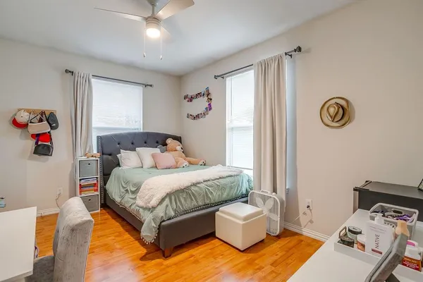 a bedroom with a bed and wooden floor
