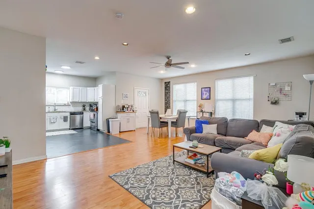 a living room with furniture and wooden floor