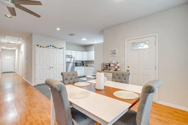 a view of a dining room with furniture and wooden floor