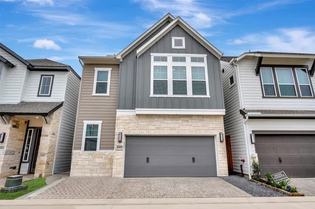 a view of a brick house with large windows