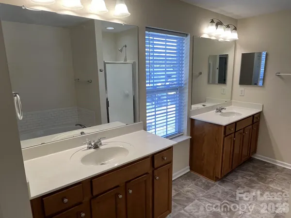 a bathroom with a sink double vanity and a mirror