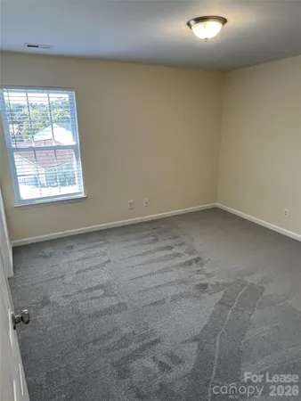 an empty room with a empty space and windows