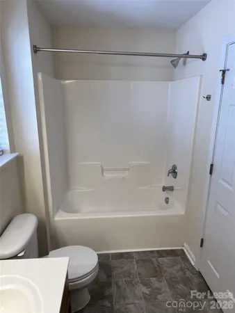 a bathroom with a shower and a toilet