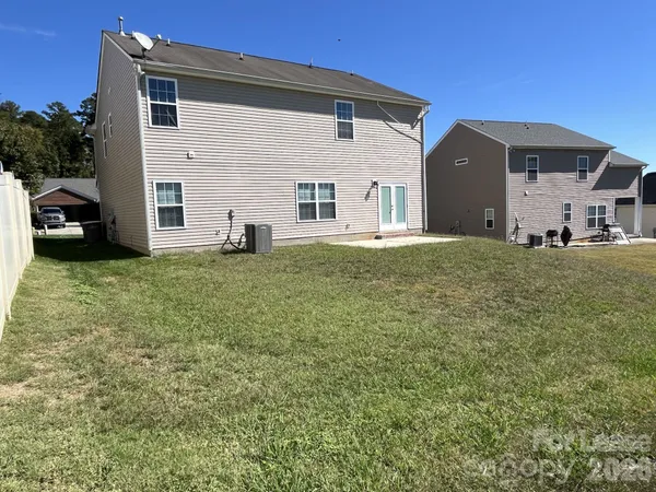 a big house with a big yard and large trees