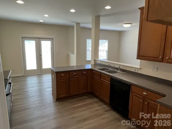 a kitchen with stainless steel appliances granite countertop a sink and wooden cabinets