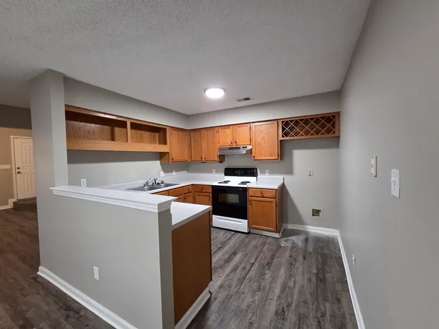 a kitchen with wooden cabinets and a sink