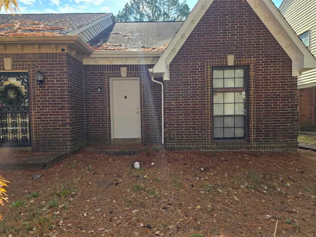a view of a house with brick walls