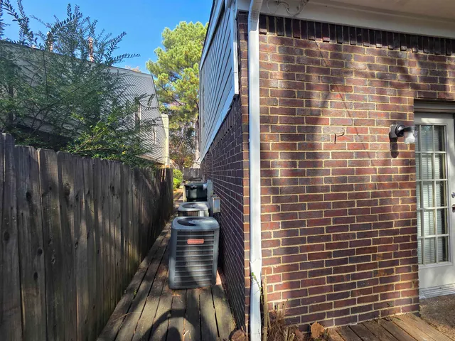a view of a pathway with a wooden fence