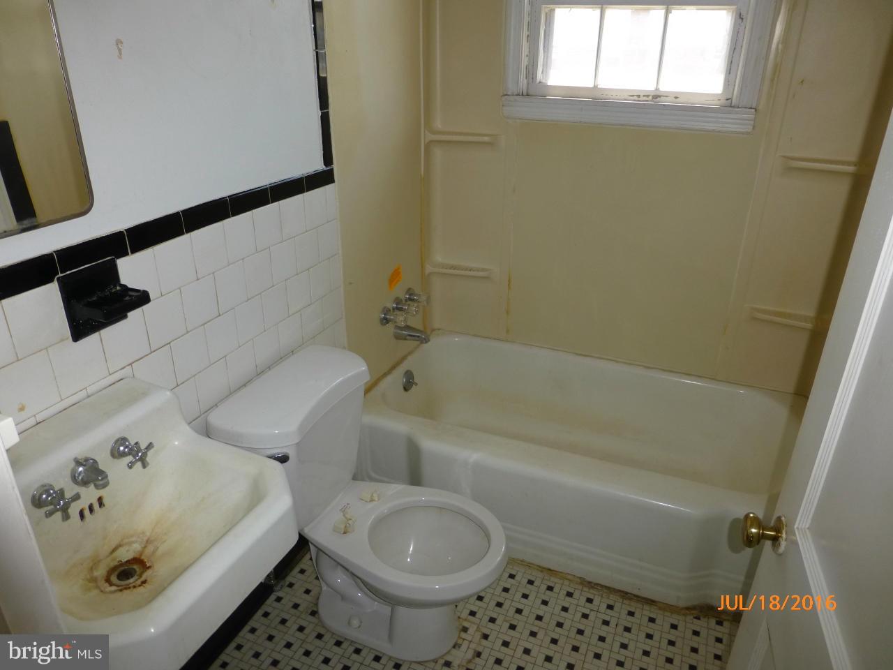 1933 Penhall Road Baltimore, MD 21222 - Photo 9 of 15 a bathroom with a bathtub and a toilet