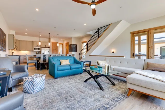 a living room with furniture and a wooden floor