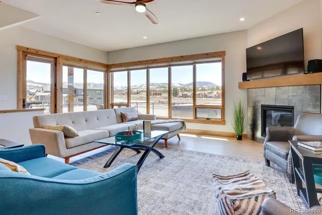 a living room with fireplace furniture and a flat screen tv