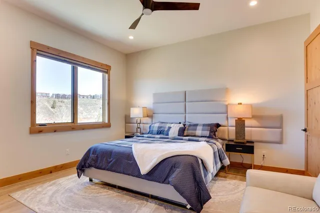 a bedroom with a bed and a large window