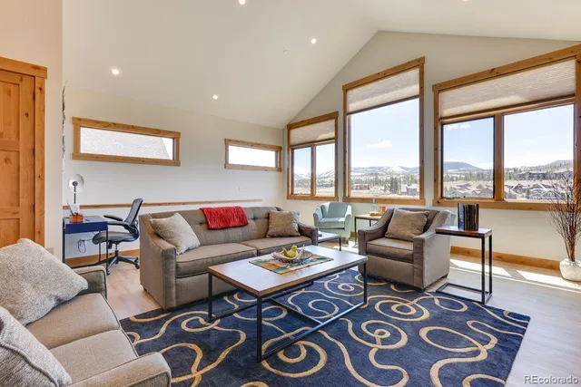a living room with furniture and a floor to ceiling window