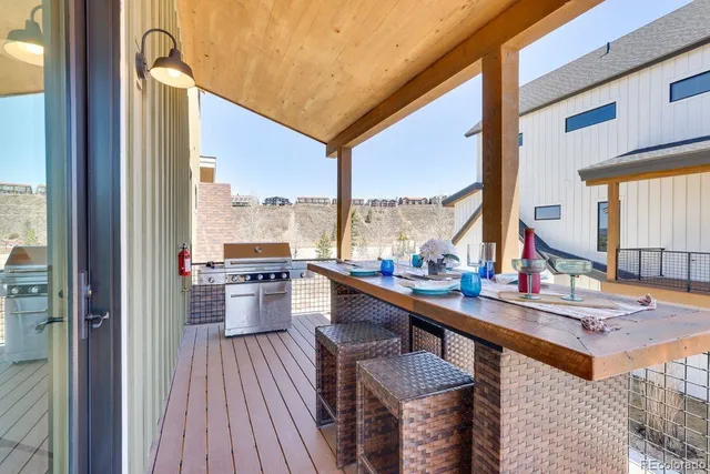 a room with wooden floor table and chairs
