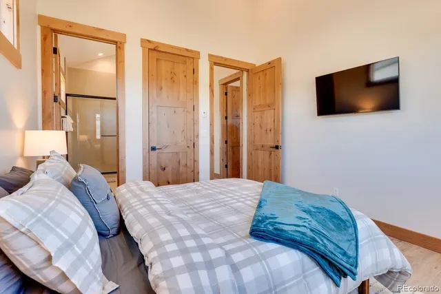 a bedroom with a bed and a flat screen tv