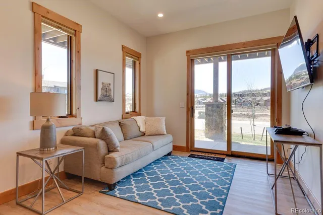 a living room with furniture and a floor to ceiling window
