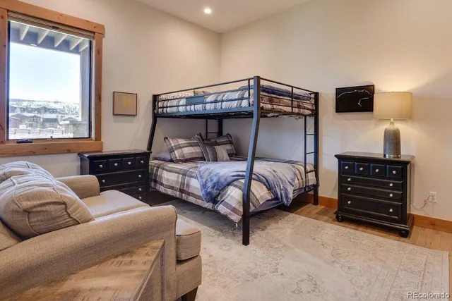 a bedroom with a bed window and a lamp