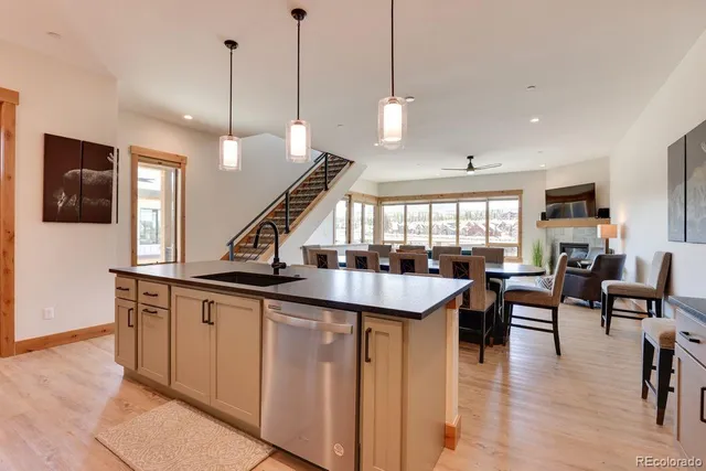 a open kitchen with stainless steel appliances granite countertop a stove and kitchen island