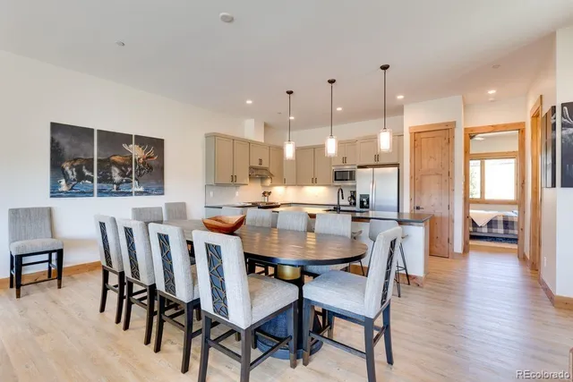 a dining room with furniture and wooden floor