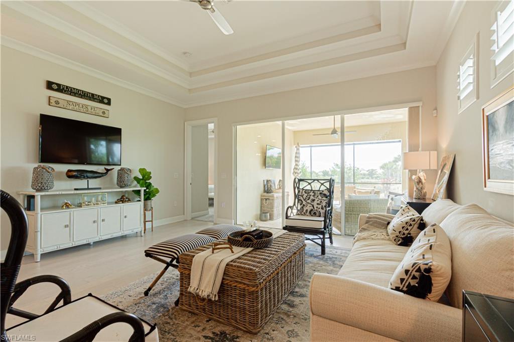 5834 Haiti Drive Naples, FL 34113 - Photo 11 of 33 a living room with furniture a large window and a flat screen tv