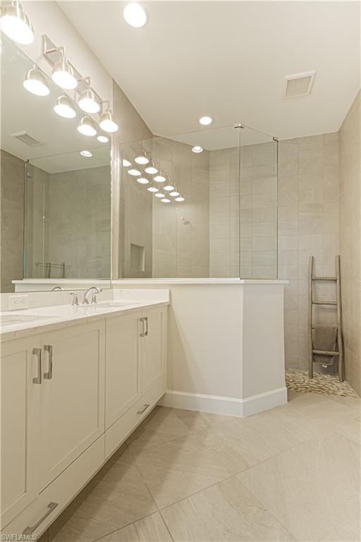 5834 Haiti Drive Naples, FL 34113 - Photo 15 of 33 a bathroom with a sink a vanity and a mirror