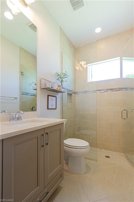 5834 Haiti Drive Naples, FL 34113 - Photo 18 of 33 a bathroom with a sink toilet and shower