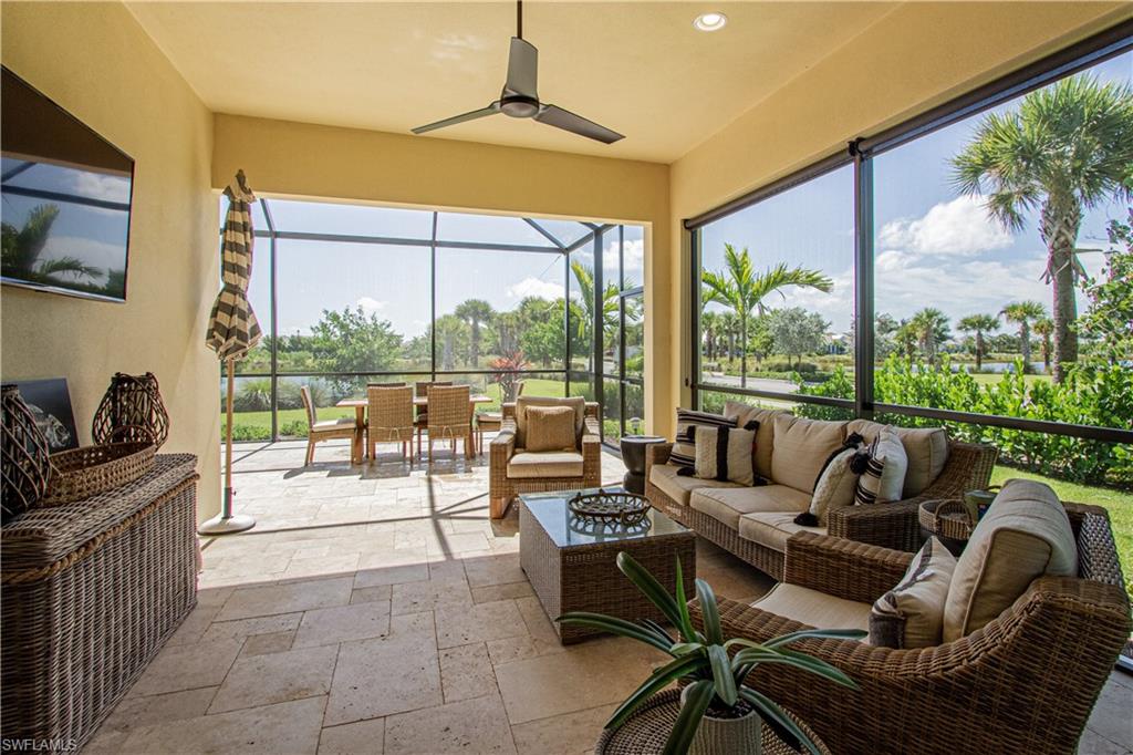 5834 Haiti Drive Naples, FL 34113 - Photo 20 of 33 a living room with furniture and a floor to ceiling window