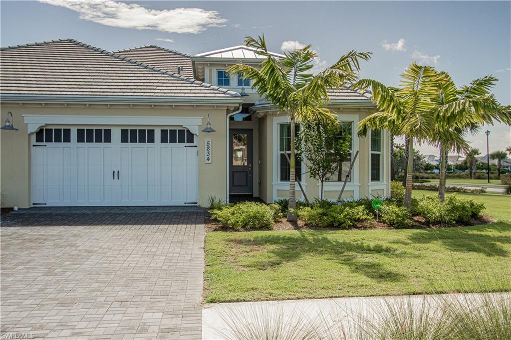 5834 Haiti Drive Naples, FL 34113 - Photo 25 of 33 a front view of a house with garden