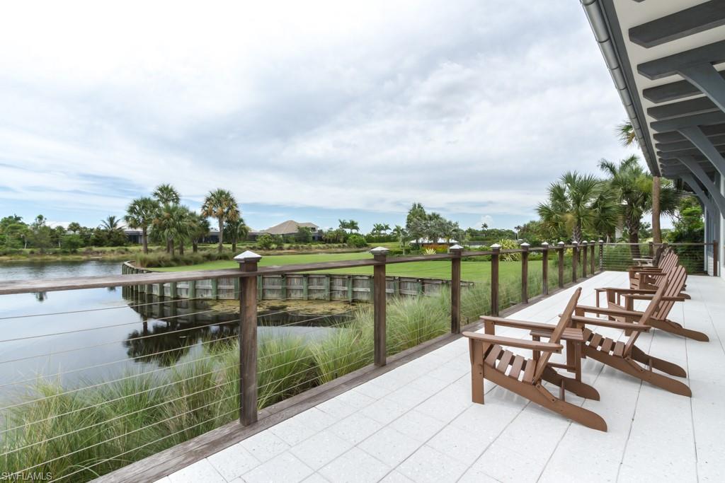5834 Haiti Drive Naples, FL 34113 - Photo 32 of 33 a view of a lake with a table and chairs next to a yard