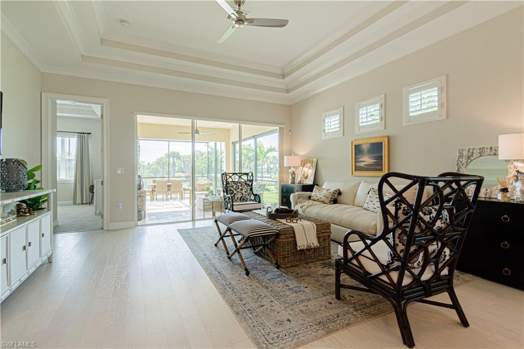 5834 Haiti Drive Naples, FL 34113 - Photo 10 of 33 a living room with furniture large windows and wooden floor
