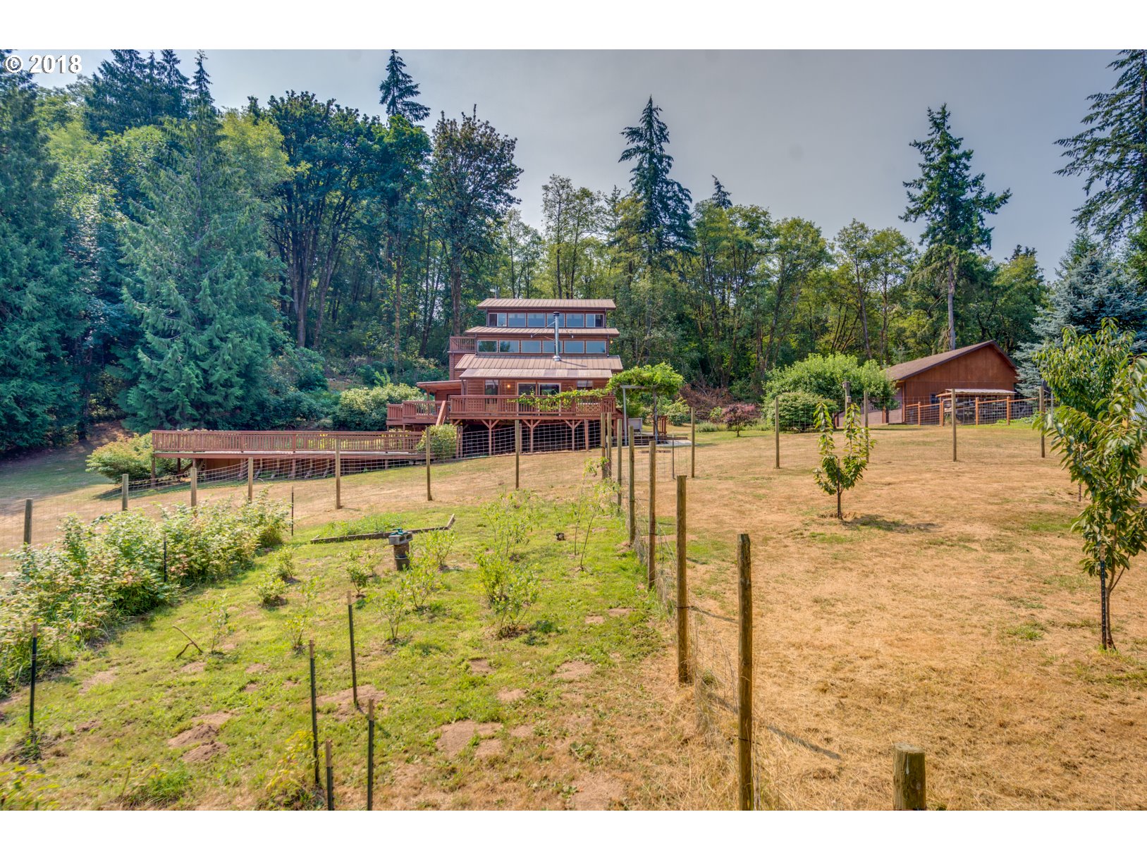 66794 Doetsch Road Deer Island, OR 97054 - Photo 27 of 32 a backyard of a house with table and chairs